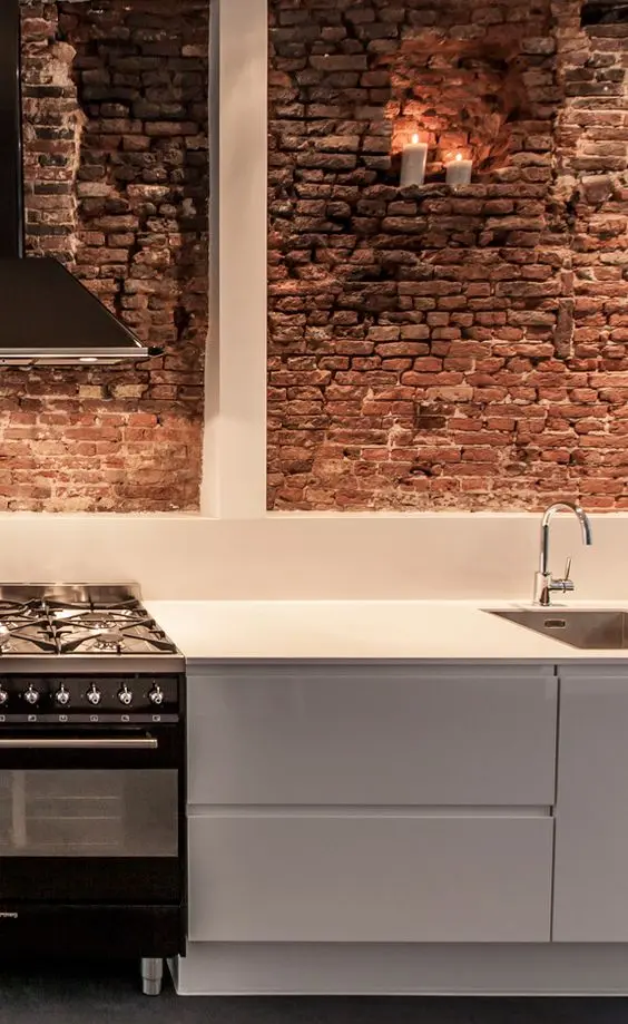modern kitchen with red brick wall