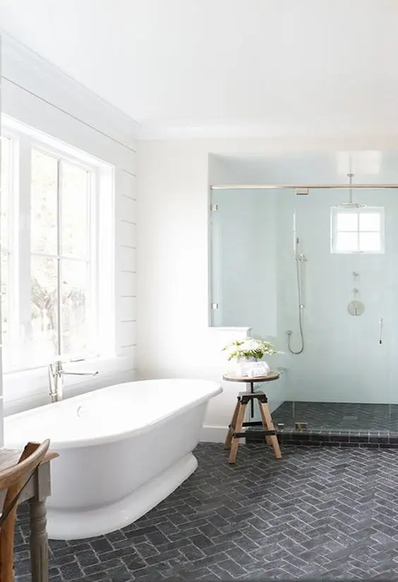 modern white bathroom with slate brick floors