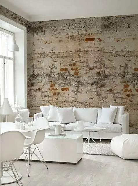 white living room with rough brick wall