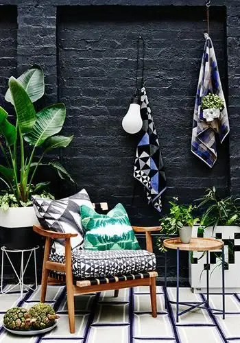 small backyard with black brick wall
