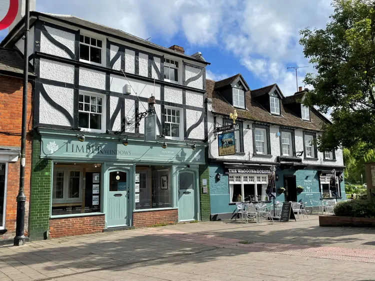 Timber-framed windows on a brick house